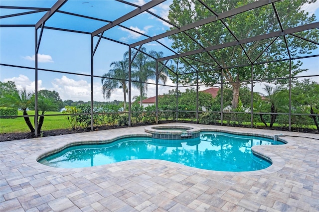 view of swimming pool with an in ground hot tub, a lanai, and a patio area