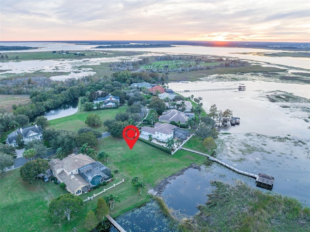 aerial view at dusk with a water view