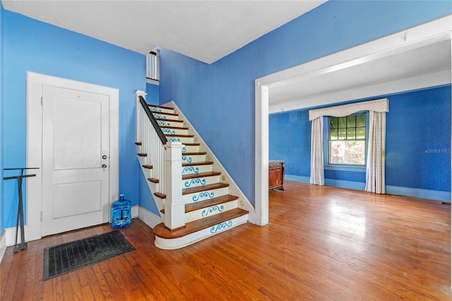 stairs featuring hardwood / wood-style flooring