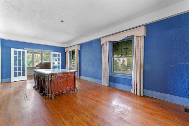 office featuring hardwood / wood-style floors and a textured ceiling