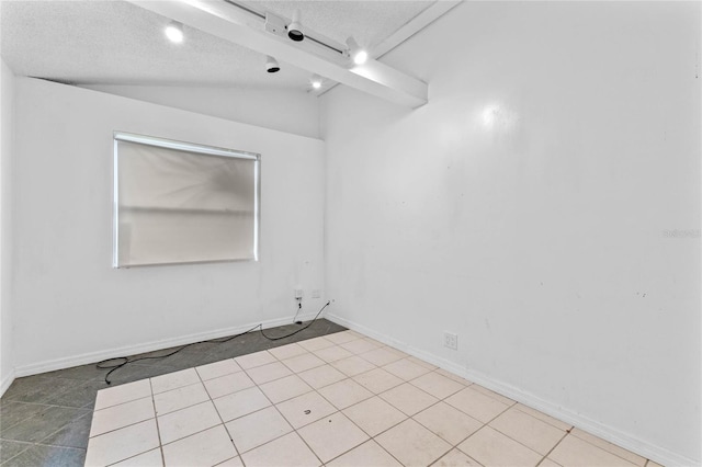 spare room featuring lofted ceiling and a textured ceiling