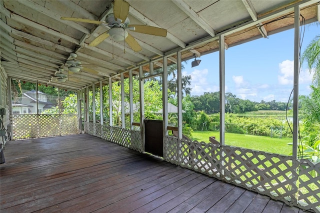 unfurnished sunroom featuring ceiling fan