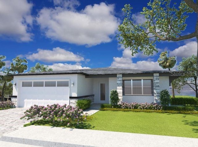 4963 Pall Mall St E, Kissimmee, FL 34758 - view of front of property with a garage, decorative driveway, a front lawn, and stucco siding