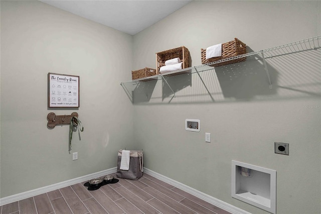 laundry area with washer hookup, wood finish floors, electric dryer hookup, laundry area, and baseboards