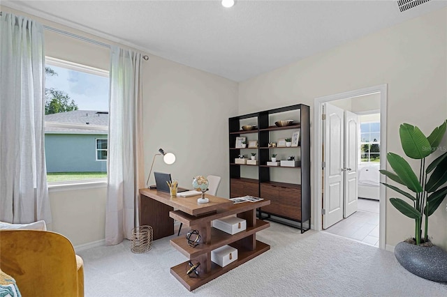 home office with visible vents and light colored carpet