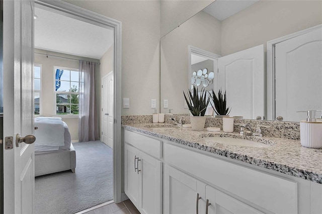 ensuite bathroom with double vanity, a sink, and ensuite bathroom