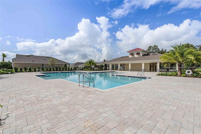 pool with fence and a patio