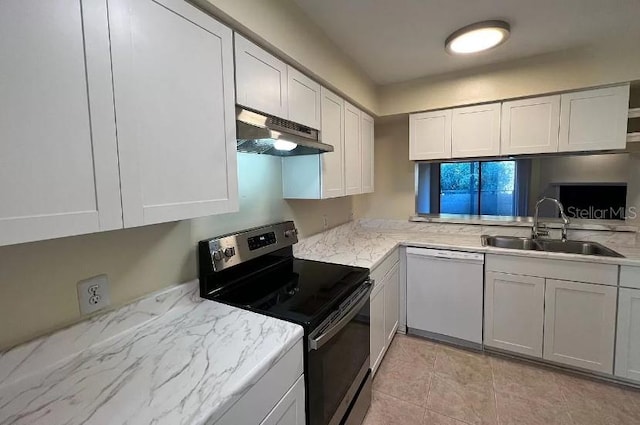 kitchen with stainless steel electric range, white cabinetry, sink, white dishwasher, and light tile patterned floors