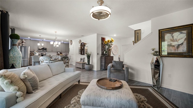 living room featuring a chandelier and dark wood-type flooring