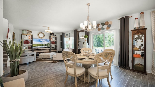 dining space with a notable chandelier and dark hardwood / wood-style flooring