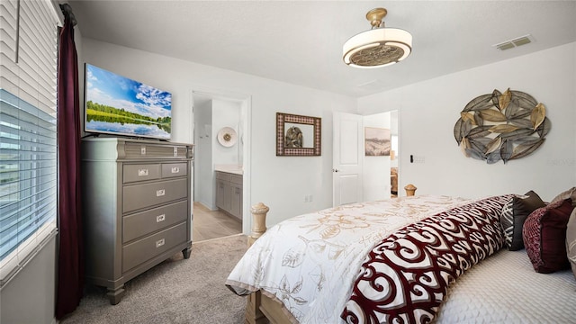 carpeted bedroom featuring connected bathroom