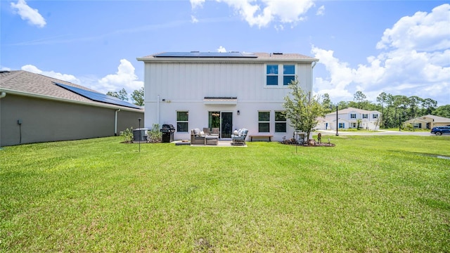 back of house featuring solar panels, a patio area, central AC unit, a yard, and an outdoor living space