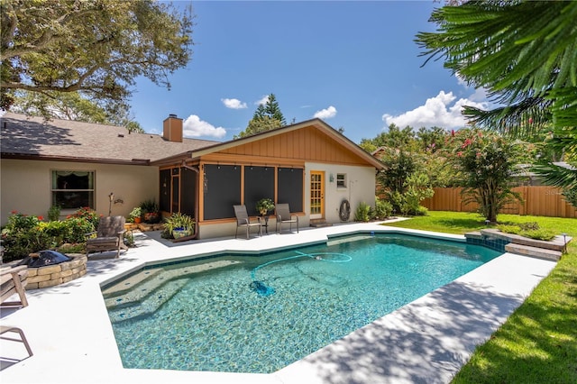 view of swimming pool with a patio area and a fire pit