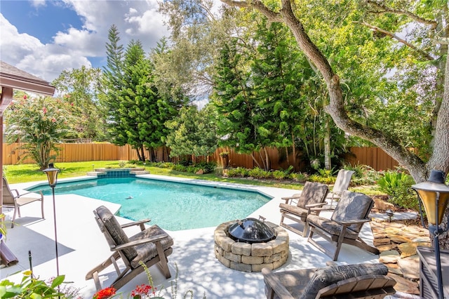 view of pool with a patio area and an outdoor fire pit