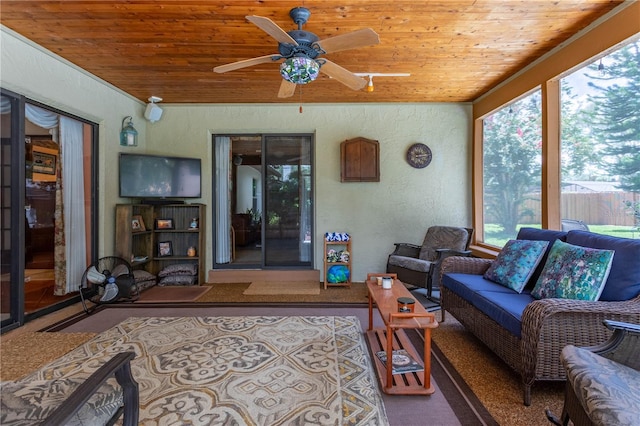 living room featuring ceiling fan and wood ceiling