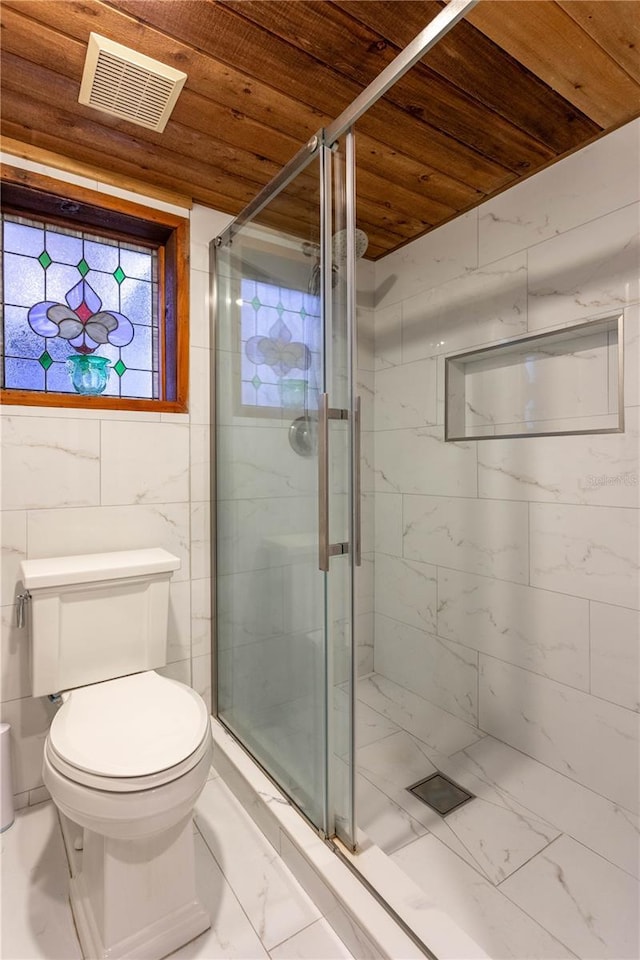 bathroom with an enclosed shower, toilet, tile walls, and wooden ceiling