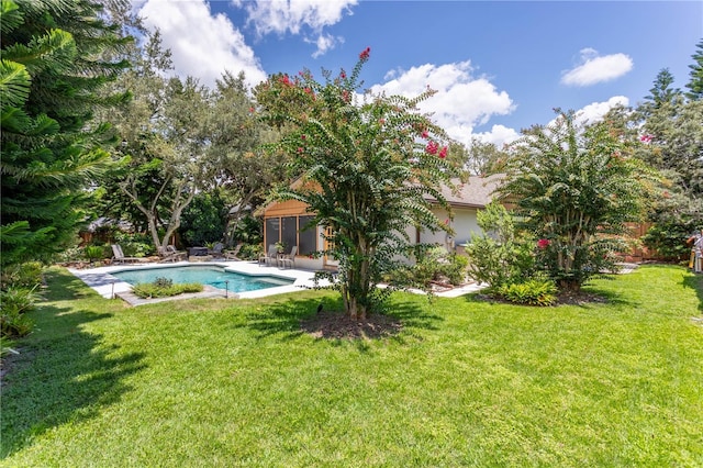 outdoor pool featuring a sunroom, a yard, and a patio