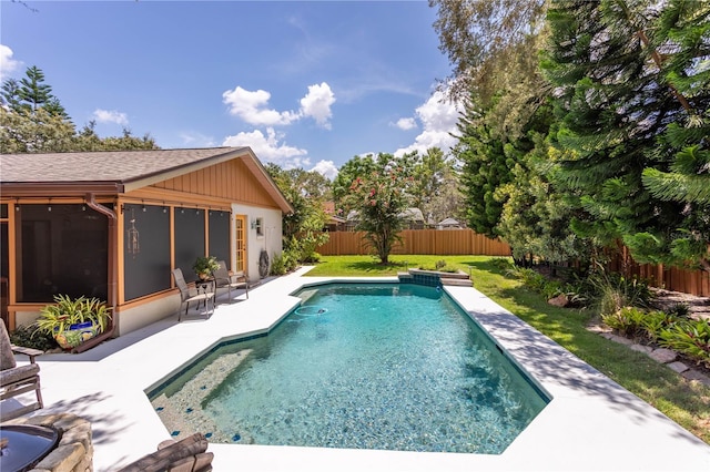 view of swimming pool featuring a patio, a fenced backyard, a sunroom, and a fenced in pool