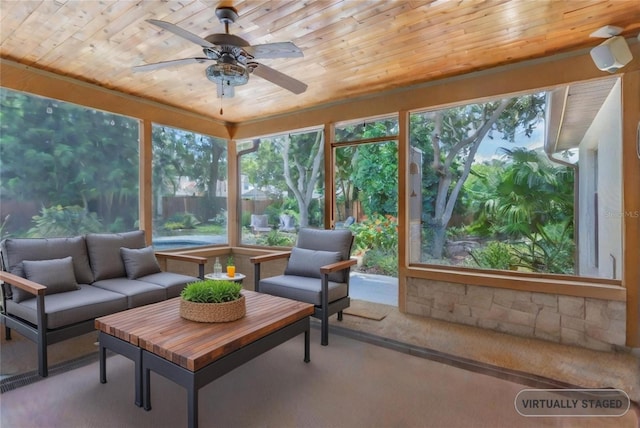 sunroom / solarium with ceiling fan, wooden ceiling, and a wealth of natural light