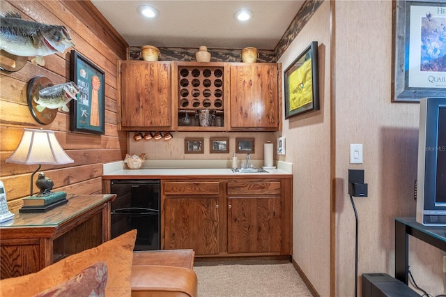 bar with a sink, baseboards, black fridge, and recessed lighting