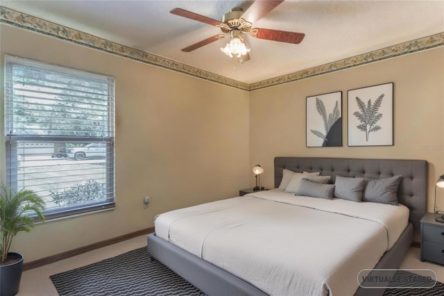 bedroom with carpet floors, multiple windows, baseboards, and a ceiling fan