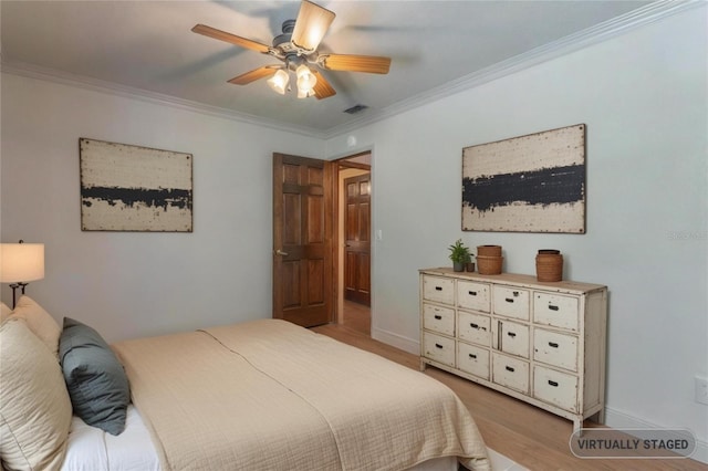 bedroom with a ceiling fan, light wood-type flooring, crown molding, and baseboards