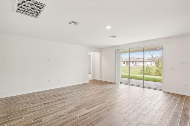 spare room with light hardwood / wood-style flooring