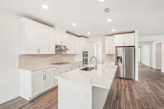 kitchen featuring white cabinets, an island with sink, stainless steel appliances, and sink