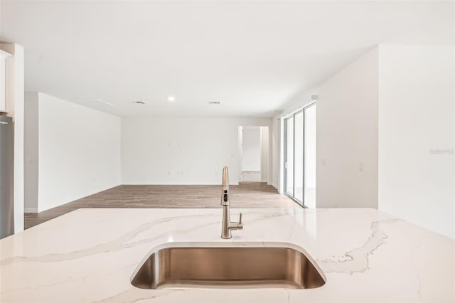 kitchen with light stone countertops and sink