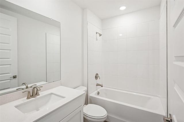 full bathroom featuring vanity, toilet, and tiled shower / bath