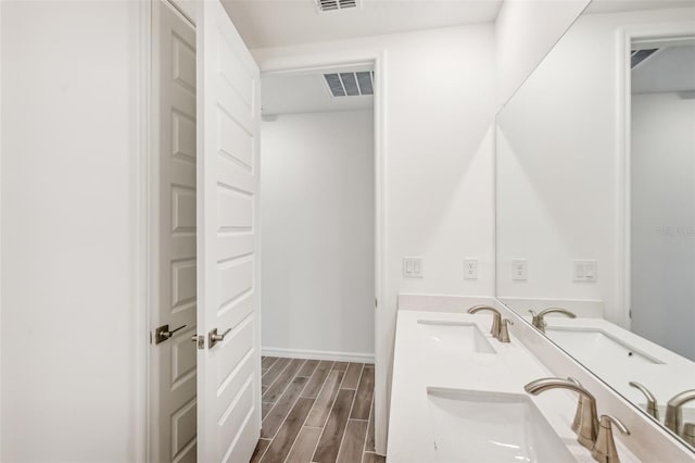 bathroom with vanity and hardwood / wood-style flooring