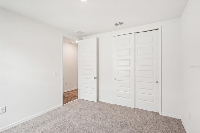 unfurnished bedroom featuring carpet floors and a closet