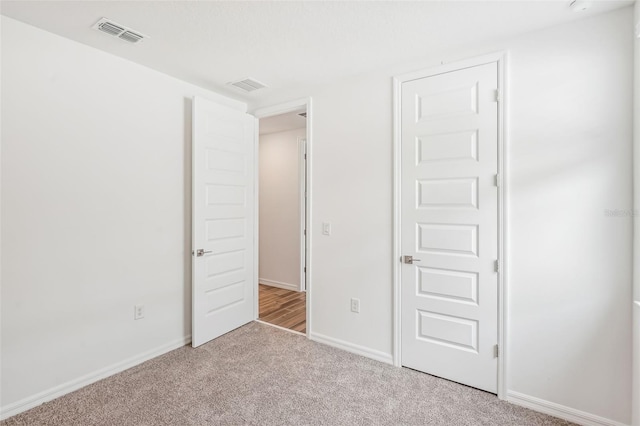 unfurnished bedroom with light carpet