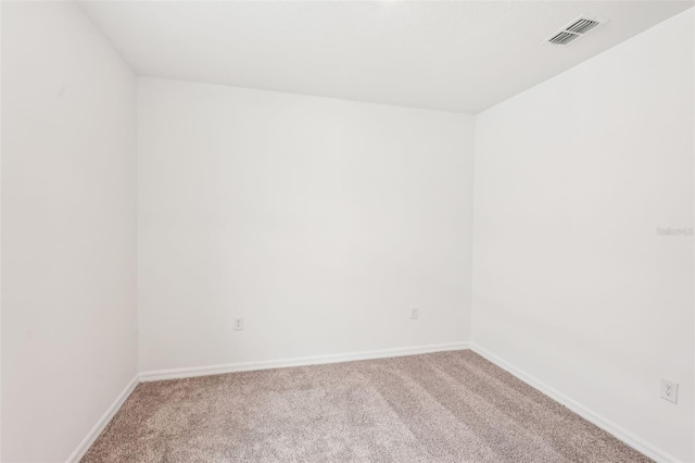 unfurnished room with light colored carpet