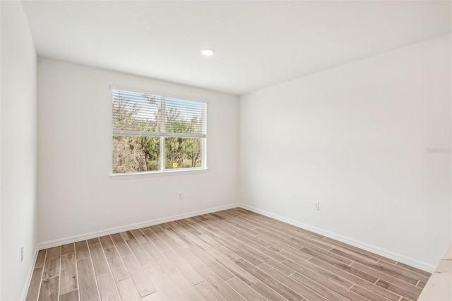 spare room with light wood-type flooring