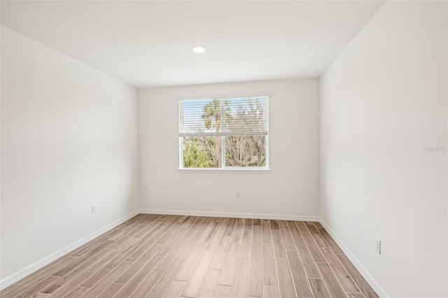 spare room with light wood-type flooring