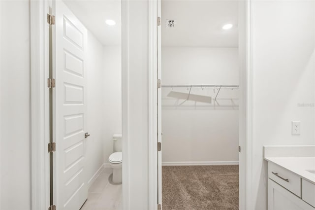 bathroom featuring vanity and toilet