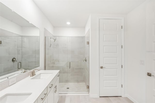 bathroom featuring vanity and a shower with shower door