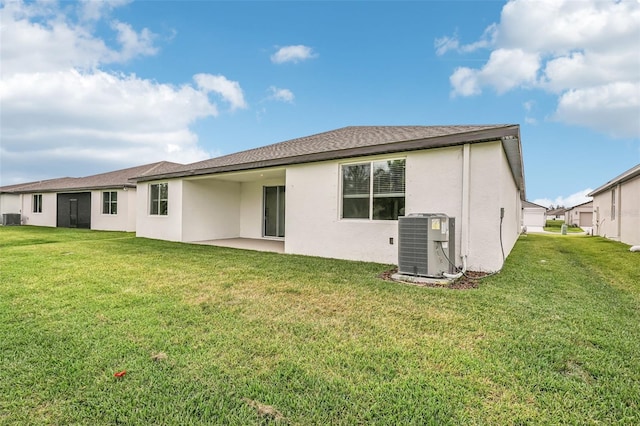 back of property featuring cooling unit, a patio area, and a lawn