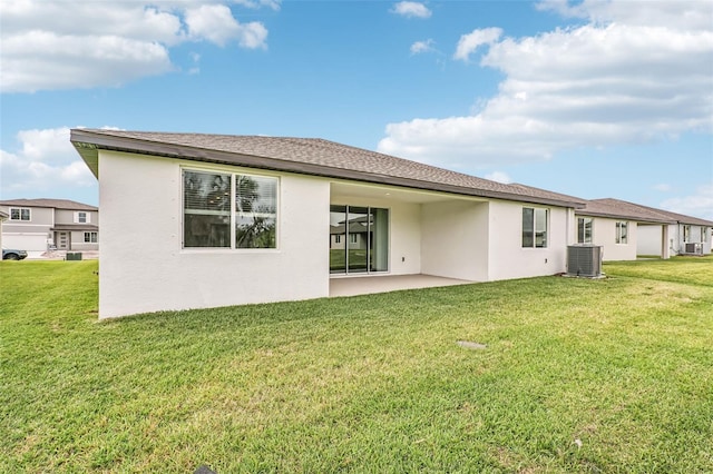 back of house featuring a patio, a yard, and central AC