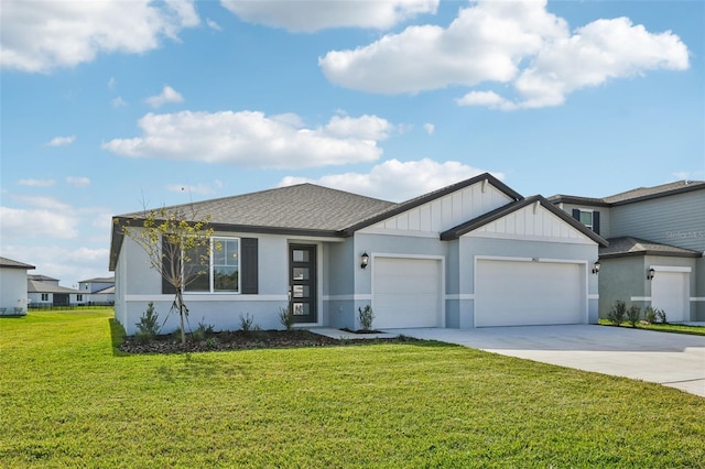 view of front of property with a front yard and a garage