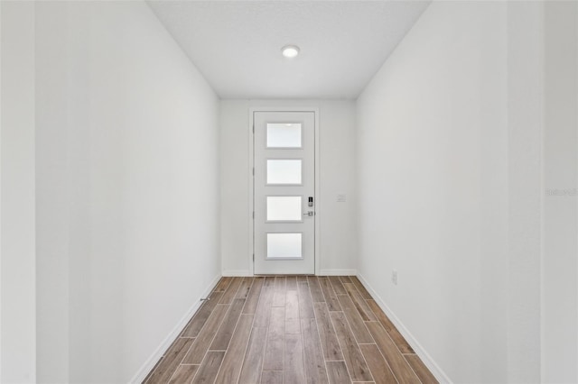 doorway with hardwood / wood-style flooring