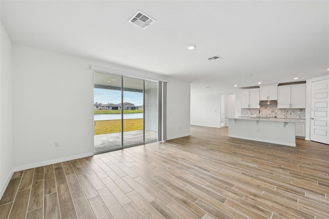 unfurnished living room featuring light hardwood / wood-style floors