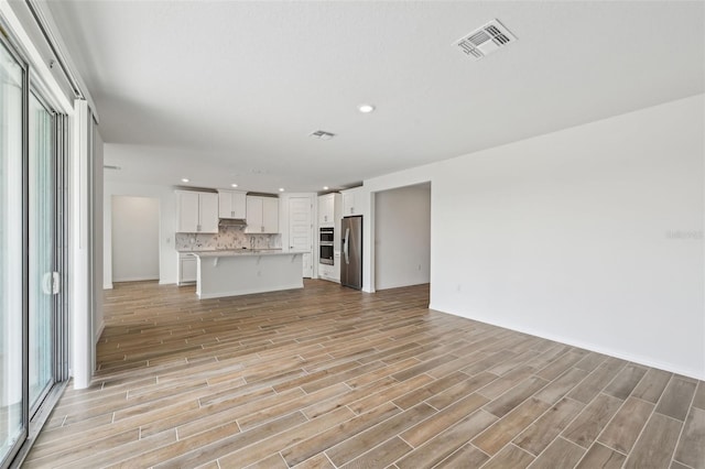 unfurnished living room featuring light hardwood / wood-style floors