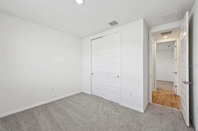 unfurnished bedroom with carpet flooring and a closet