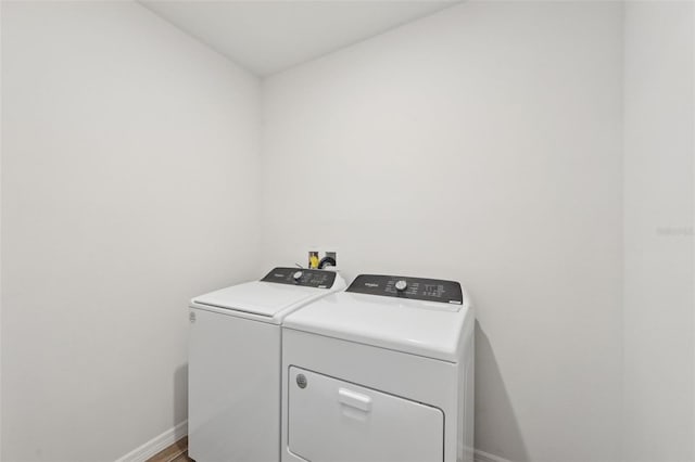 clothes washing area featuring independent washer and dryer