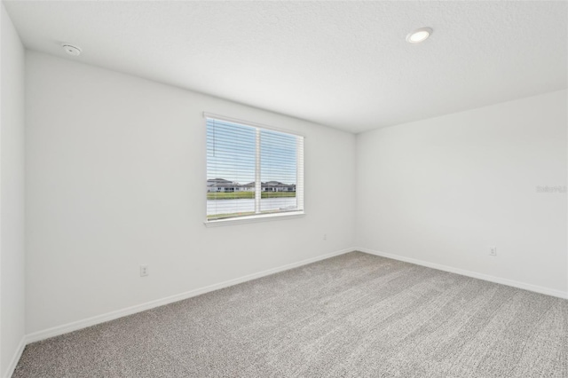 spare room featuring carpet flooring