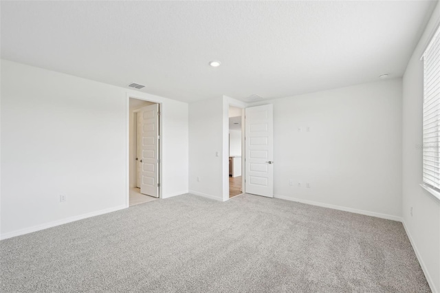 spare room with light colored carpet