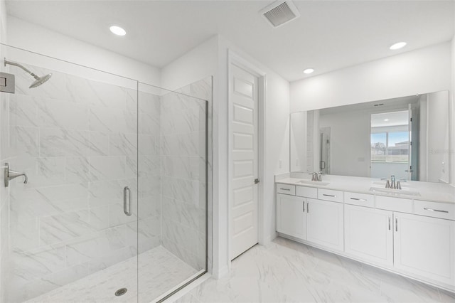 bathroom with walk in shower and vanity