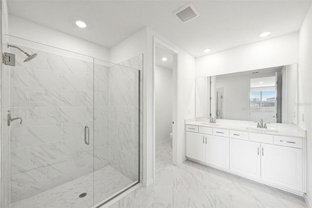 bathroom with toilet, a shower with shower door, and vanity